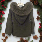 Dark green knitted jacket with fur hood on a white background