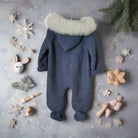 Blue baby onesie with fur hood on a white background
