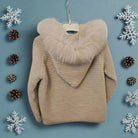 Beige sweater with fur hood on a white background