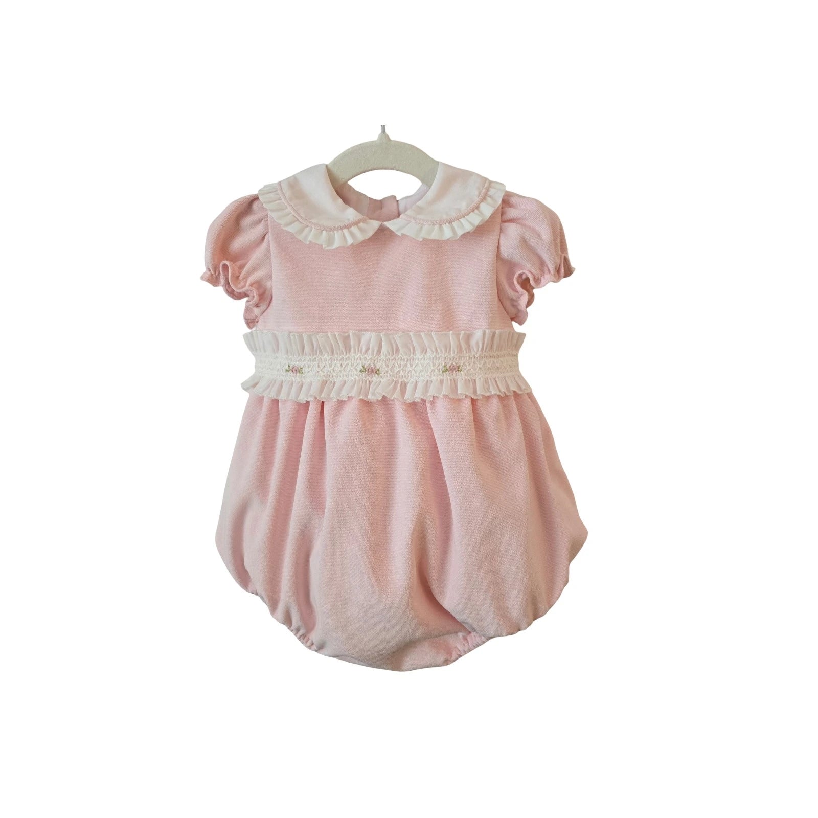 Pink baby romper with white collar on a white background