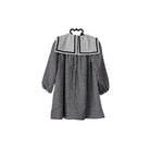 Black and white checkered dress on a hanger against a white background