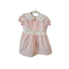 Pink dress with white ruffled collar on a white background