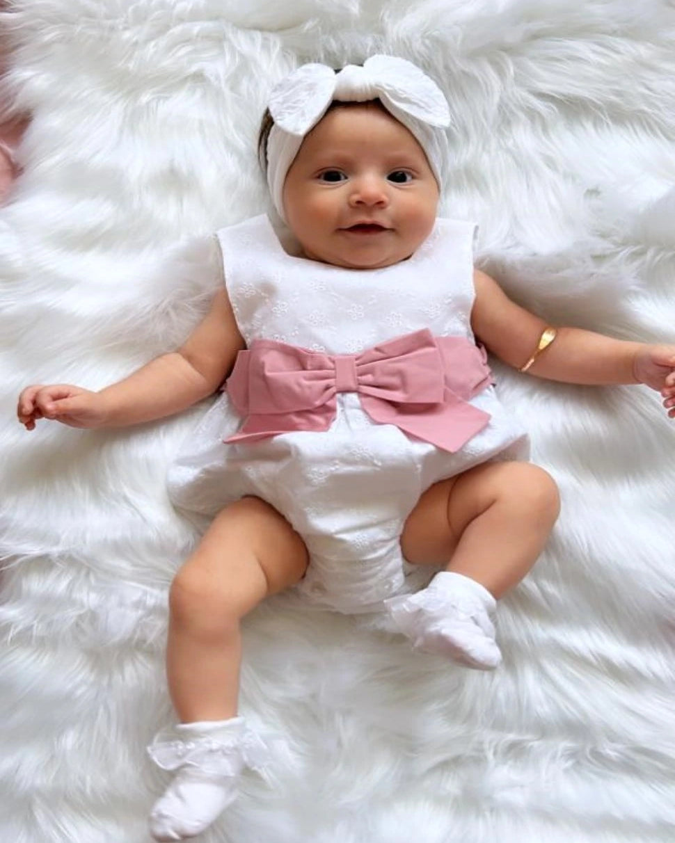 white baby romper with large pink bow by sardon at tors childrens wear