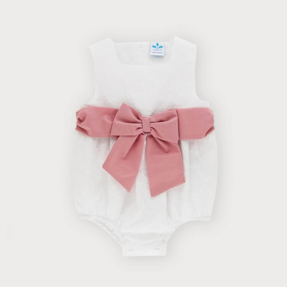 white baby romper with large pink bow by sardon